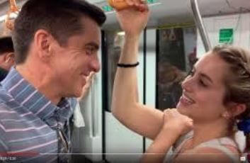 Maggie Thurmon with her father, Dan Thurmon, riding a subway.